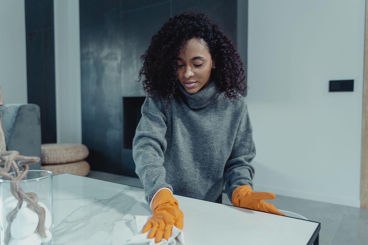 A house cleaner wiping a table